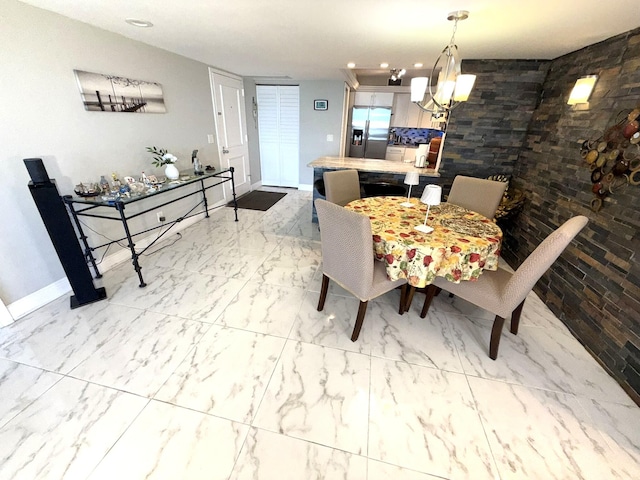2425 Presidential Way Unit 1804, West Palm Beach, FL 33401 - dining space with a chandelier, marble look tiles, and baseboards