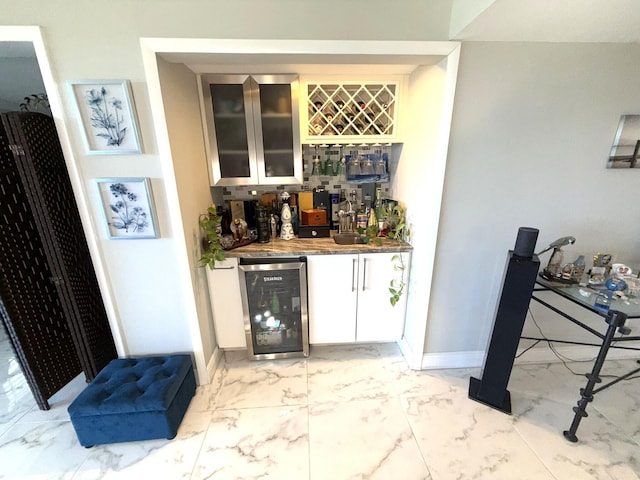 2425 Presidential Way Unit 1804, West Palm Beach, FL 33401 - indoor bar featuring beverage cooler, light marble finish flooring, and baseboards