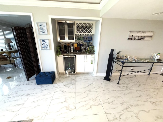 2425 Presidential Way Unit 1804, West Palm Beach, FL 33401 - indoor dry bar featuring beverage cooler, light marble finish flooring, and crown molding