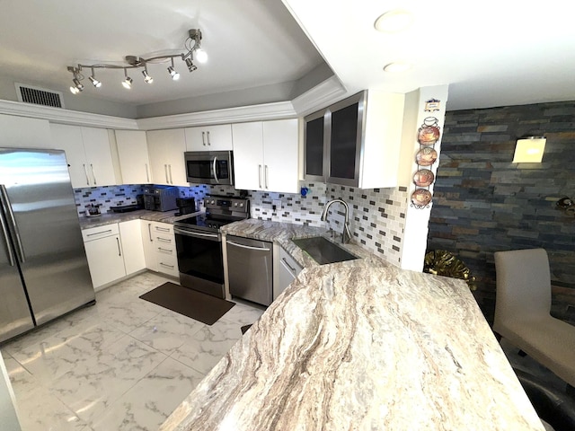 2425 Presidential Way Unit 1804, West Palm Beach, FL 33401 - kitchen featuring stainless steel appliances, a sink, light stone counters, white cabinetry, and light marble finish floors