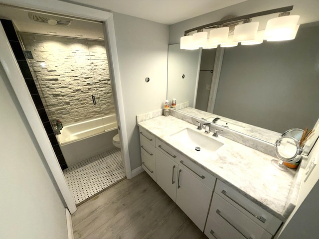 2425 Presidential Way Unit 1804, West Palm Beach, FL 33401 - full bath with vanity, toilet, wood finished floors, bathtub / shower combination, and baseboards