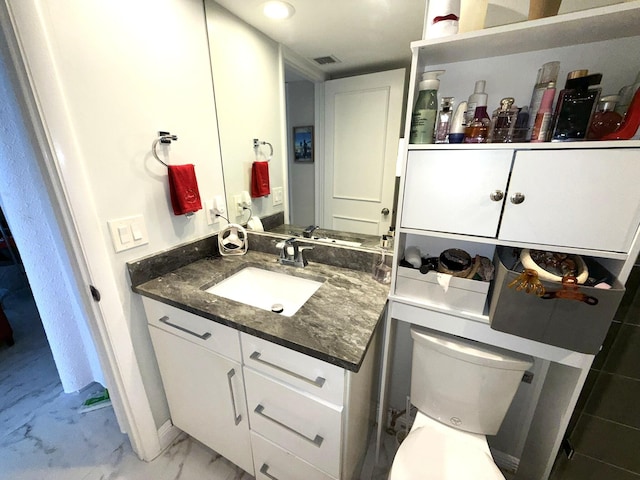 2425 Presidential Way Unit 1804, West Palm Beach, FL 33401 - bathroom with vanity, toilet, and marble look tiles