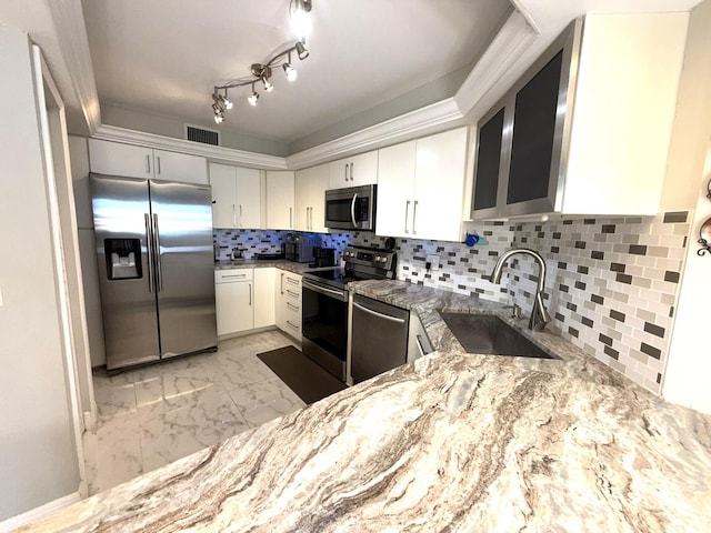 2425 Presidential Way Unit 1804, West Palm Beach, FL 33401 - kitchen featuring stainless steel appliances, a sink, light marble finish flooring, light stone countertops, and white cabinets