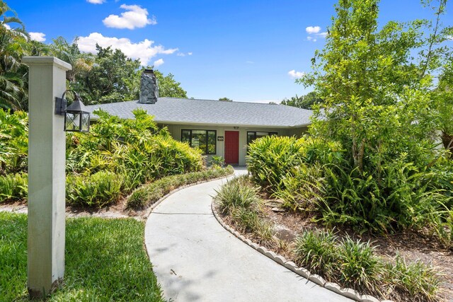 4904 River Pl, Fort Pierce, FL 34982 - view of front of property with a chimney and roof with shingles