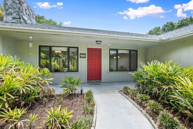 4904 River Pl, Fort Pierce, FL 34982 - property entrance featuring a porch, roof with shingles, and a chimney