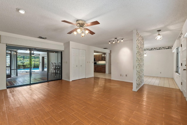4904 River Pl, Fort Pierce, FL 34982 - unfurnished room with ceiling fan, a textured ceiling, light wood-type flooring, and baseboards