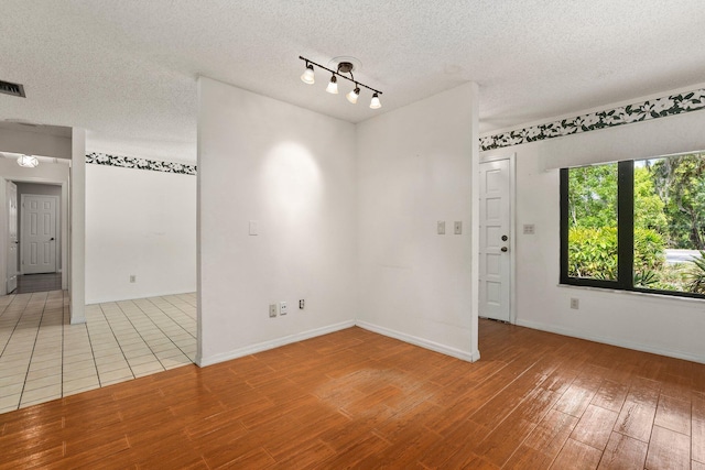 4904 River Pl, Fort Pierce, FL 34982 - empty room featuring wood finished floors, a textured ceiling, and baseboards