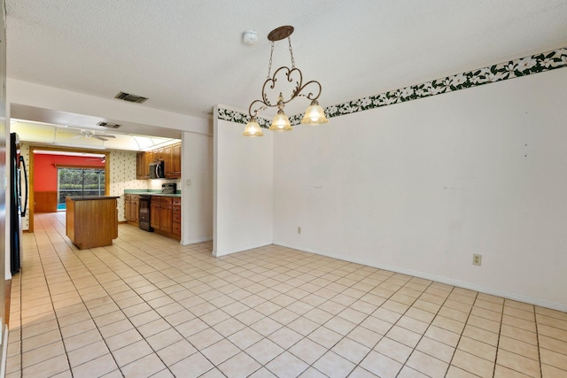 4904 River Pl, Fort Pierce, FL 34982 - kitchen with black appliances, a chandelier, dark countertops, brown cabinets, and open floor plan
