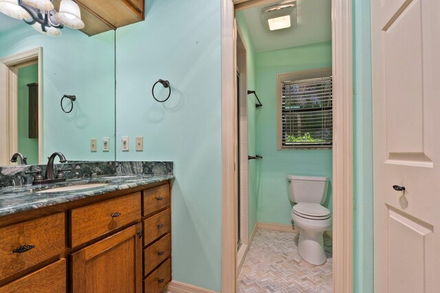 4904 River Pl, Fort Pierce, FL 34982 - full bathroom with vanity, toilet, a stall shower, baseboards, and a chandelier