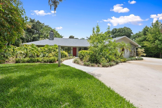 4904 River Pl, Fort Pierce, FL 34982 - view of front of property with a chimney and a front lawn