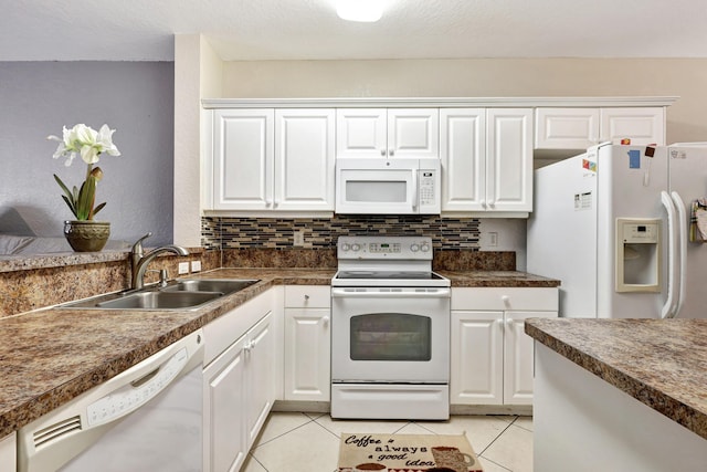 3423 Sonoma Dr, Riviera Beach, FL 33404 - kitchen with white appliances, a sink, white cabinetry, and light tile patterned floors