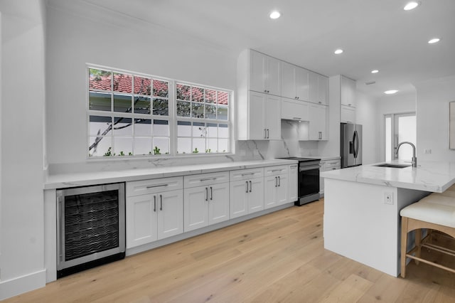 4689 Hammock Cir, Delray Beach, FL 33445 - kitchen featuring beverage cooler, electric stove, stainless steel fridge with ice dispenser, a sink, and recessed lighting