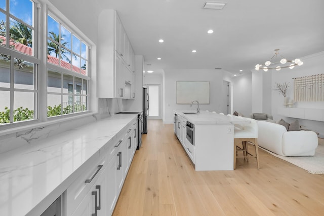 4689 Hammock Cir, Delray Beach, FL 33445 - kitchen featuring a sink, light wood-style floors, recessed lighting, appliances with stainless steel finishes, and white cabinetry
