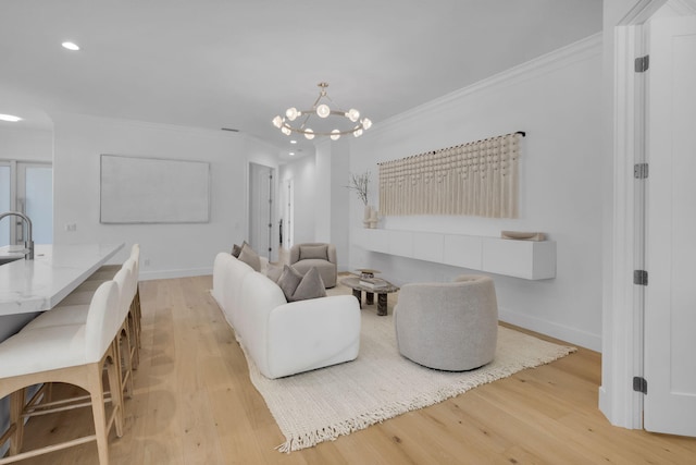 4689 Hammock Cir, Delray Beach, FL 33445 - living area with light wood finished floors, crown molding, recessed lighting, a chandelier, and baseboards