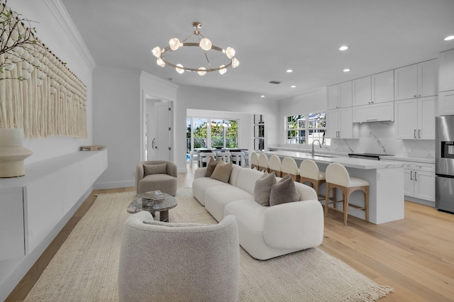 4689 Hammock Cir, Delray Beach, FL 33445 - living room featuring ornamental molding, recessed lighting, a chandelier, and light wood-style flooring