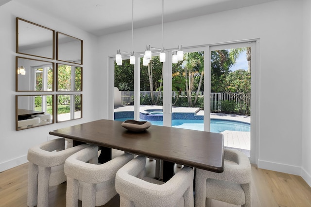 4689 Hammock Cir, Delray Beach, FL 33445 - dining space with light wood-style flooring and baseboards