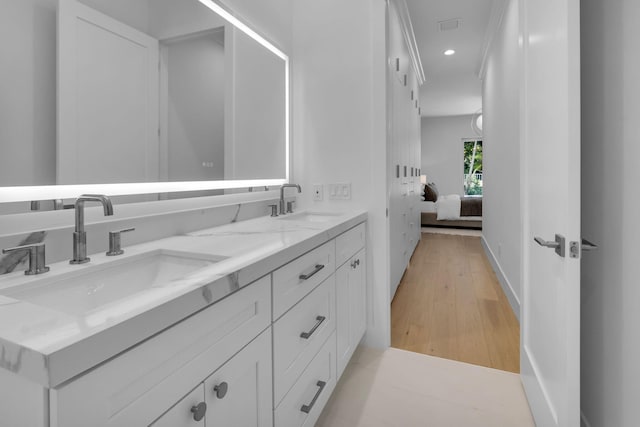 4689 Hammock Cir, Delray Beach, FL 33445 - ensuite bathroom featuring double vanity, wood finished floors, and recessed lighting