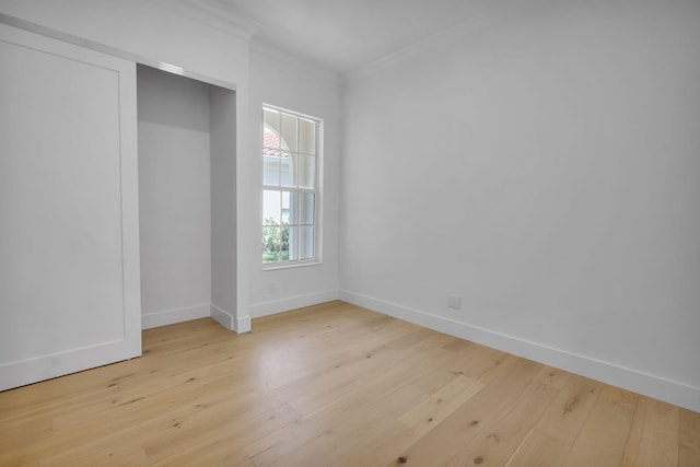 4689 Hammock Cir, Delray Beach, FL 33445 - unfurnished bedroom featuring ornamental molding, light wood-style flooring, and baseboards