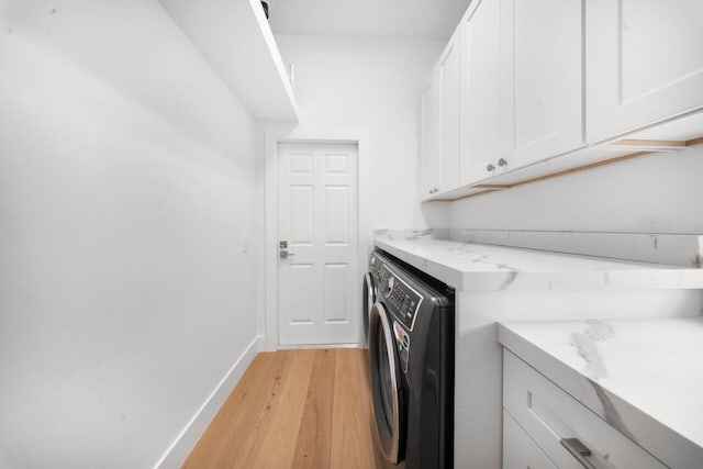 4689 Hammock Cir, Delray Beach, FL 33445 - laundry room with cabinet space, light wood-style floors, baseboards, and washer and clothes dryer