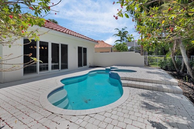 4689 Hammock Cir, Delray Beach, FL 33445 - view of pool featuring a patio, a fenced backyard, and a pool with connected hot tub