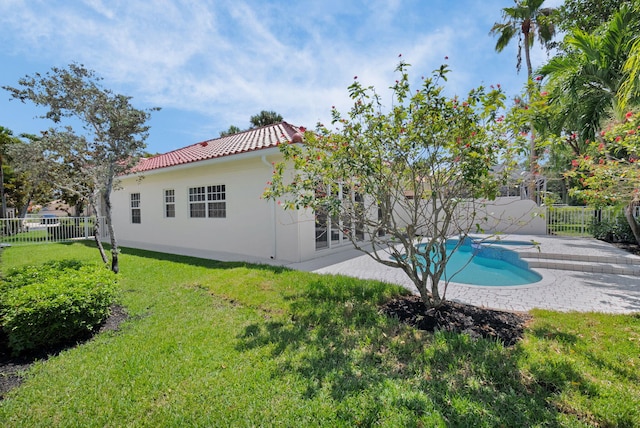 4689 Hammock Cir, Delray Beach, FL 33445 - back of house with a tile roof, a patio, and stucco siding