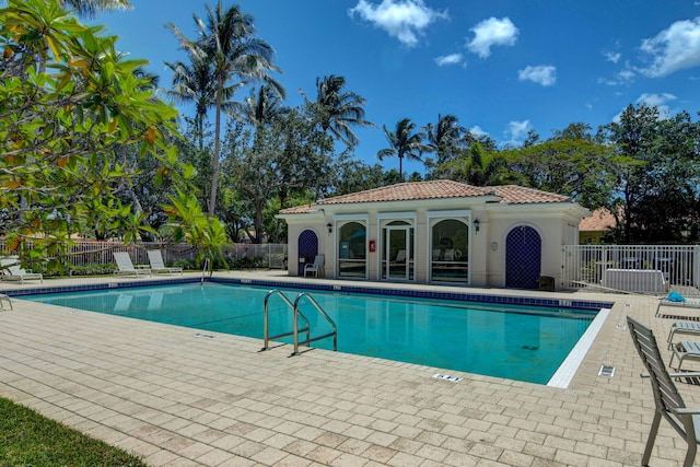 4689 Hammock Cir, Delray Beach, FL 33445 - community pool featuring a patio area and an outbuilding