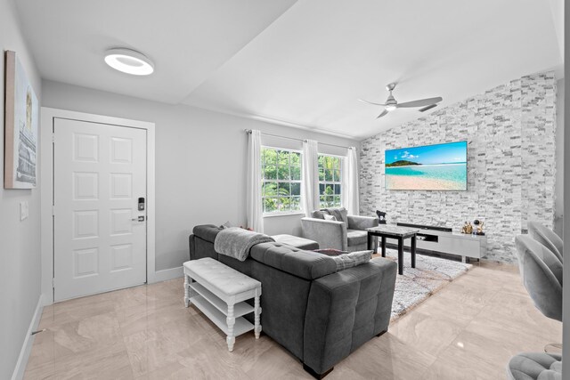 2471 SE Leithgow St, Port Saint Lucie, FL 34952 - living room featuring a ceiling fan, baseboards, and lofted ceiling