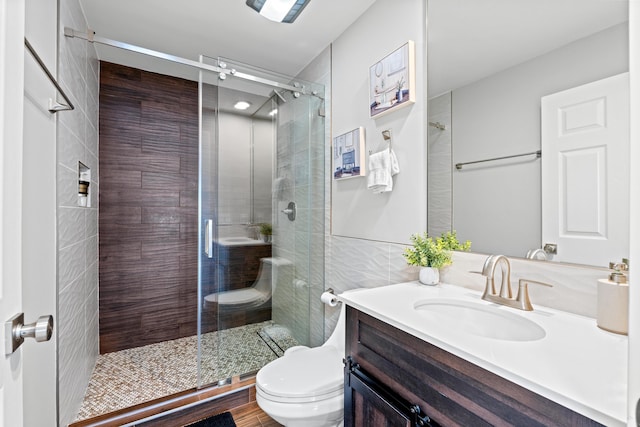 2471 SE Leithgow St, Port Saint Lucie, FL 34952 - bathroom with toilet, vanity, and a stall shower