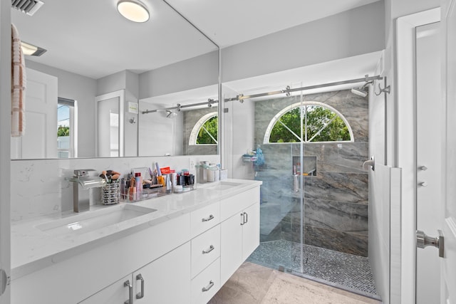 2471 SE Leithgow St, Port Saint Lucie, FL 34952 - bathroom with double vanity, healthy amount of natural light, and a shower stall