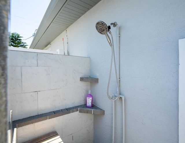 2471 SE Leithgow St, Port Saint Lucie, FL 34952 - bathroom view of a tile shower and stucco siding