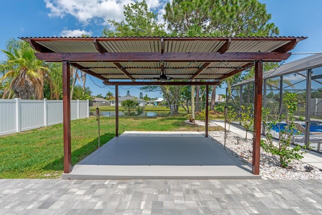 2471 SE Leithgow St, Port Saint Lucie, FL 34952 - view of parking featuring a ceiling fan, a water view, and an outdoor pool
