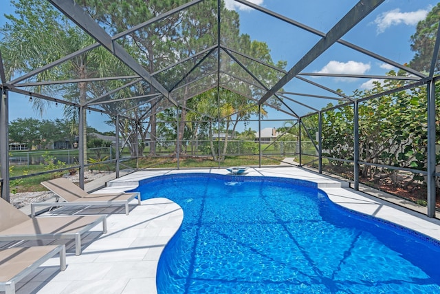 2471 SE Leithgow St, Port Saint Lucie, FL 34952 - outdoor pool featuring a patio and glass enclosure