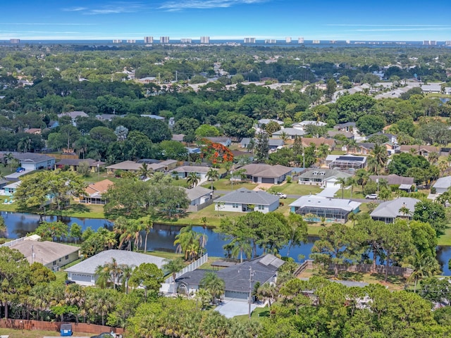 2471 SE Leithgow St, Port Saint Lucie, FL 34952 - aerial view of residential area with a nearby body of water and a tree filled landscape