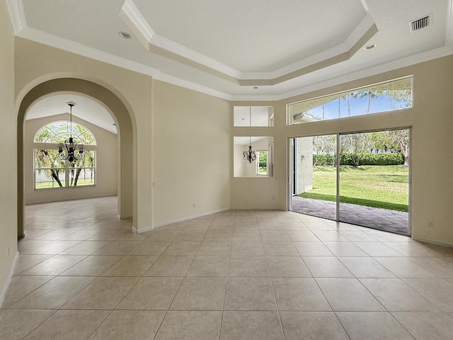 7725 Royale River Ln, Lake Worth, FL 33467 - spare room with a chandelier, a tray ceiling, light tile patterned floors, and ornamental molding