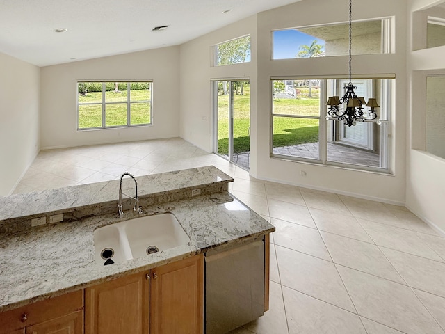 7725 Royale River Ln, Lake Worth, FL 33467 - kitchen featuring healthy amount of natural light, a sink, light tile patterned floors, light stone countertops, and vaulted ceiling
