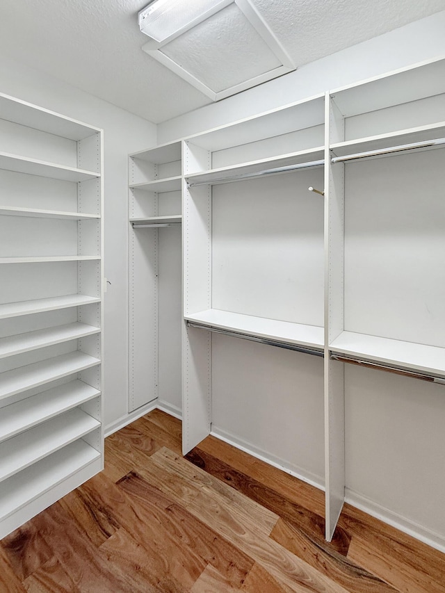 7725 Royale River Ln, Lake Worth, FL 33467 - walk in closet featuring wood finished floors and attic access