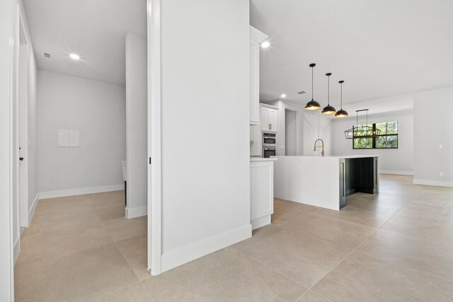 13590 82nd St N, Loxahatchee, FL 33470 - kitchen with a sink, white cabinets, recessed lighting, a center island with sink, and light countertops