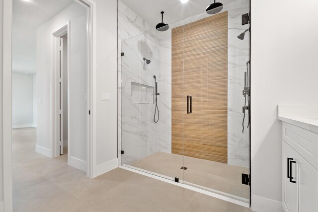13590 82nd St N, Loxahatchee, FL 33470 - bathroom featuring a marble finish shower, vanity, and baseboards