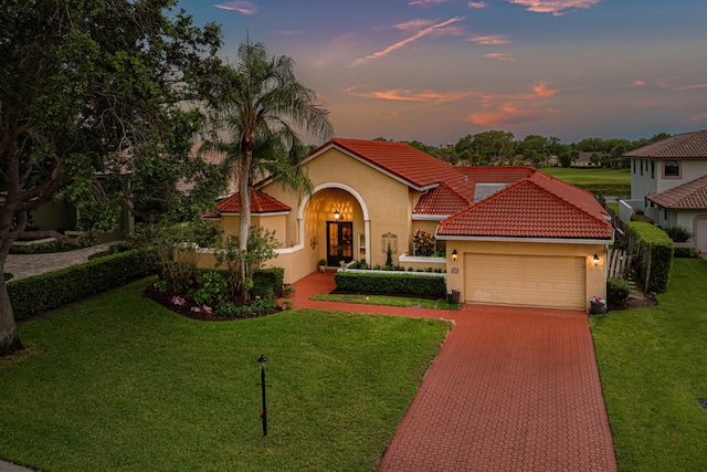 5986 Vista Linda Ln, Boca Raton, FL 33433 - mediterranean / spanish home with an attached garage, stucco siding, decorative driveway, and a front lawn