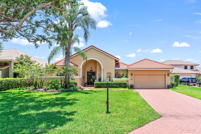 5986 Vista Linda Ln, Boca Raton, FL 33433 - mediterranean / spanish house featuring stucco siding, a garage, decorative driveway, a front yard, and a tiled roof
