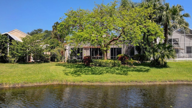 6690 Remington Pl, Lake Worth, FL 33463 - rear view of house with a water view and a lawn