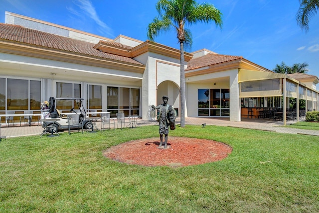 6690 Remington Pl, Lake Worth, FL 33463 - rear view of property with a tile roof, a patio area, and a yard