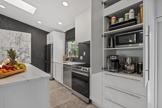 14244 Horseshoe Trce, Wellington, FL 33414 - kitchen featuring appliances with stainless steel finishes, a sink, white cabinetry, vaulted ceiling, and recessed lighting