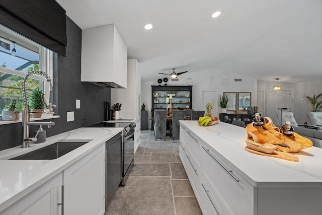 14244 Horseshoe Trce, Wellington, FL 33414 - kitchen with lofted ceiling, a center island, a sink, white cabinetry, and light stone finish floors