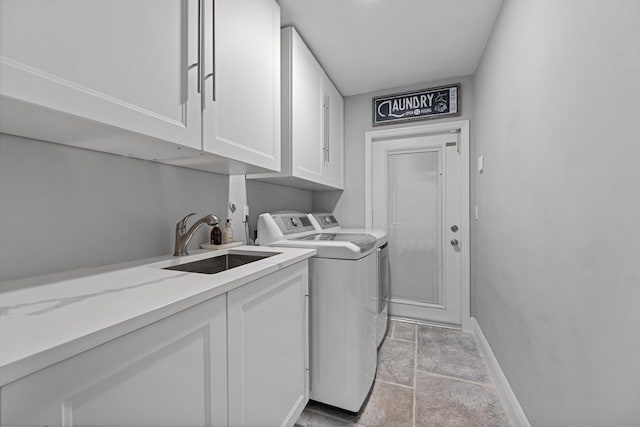 14244 Horseshoe Trce, Wellington, FL 33414 - laundry area with independent washer and dryer, cabinet space, baseboards, and light stone finish floors