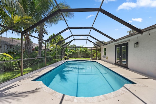 14244 Horseshoe Trce, Wellington, FL 33414 - swimming pool with french doors, a patio area, and glass enclosure