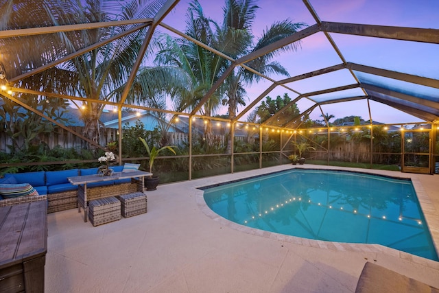 14244 Horseshoe Trce, Wellington, FL 33414 - pool at dusk featuring an outdoor hangout area, a patio area, and a lanai