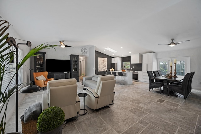 14244 Horseshoe Trce, Wellington, FL 33414 - living room featuring ceiling fan, stone tile floors, recessed lighting, and lofted ceiling
