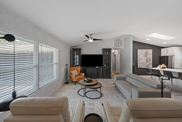 14244 Horseshoe Trce, Wellington, FL 33414 - living room with lofted ceiling, a skylight, a ceiling fan, light stone finish flooring, and recessed lighting