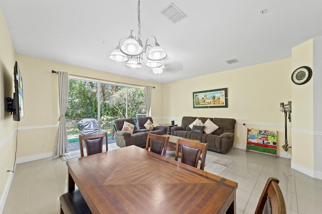 899 Pipers Cay Dr, West Palm Beach, FL 33415 - dining area featuring light tile patterned floors, a chandelier, and baseboards